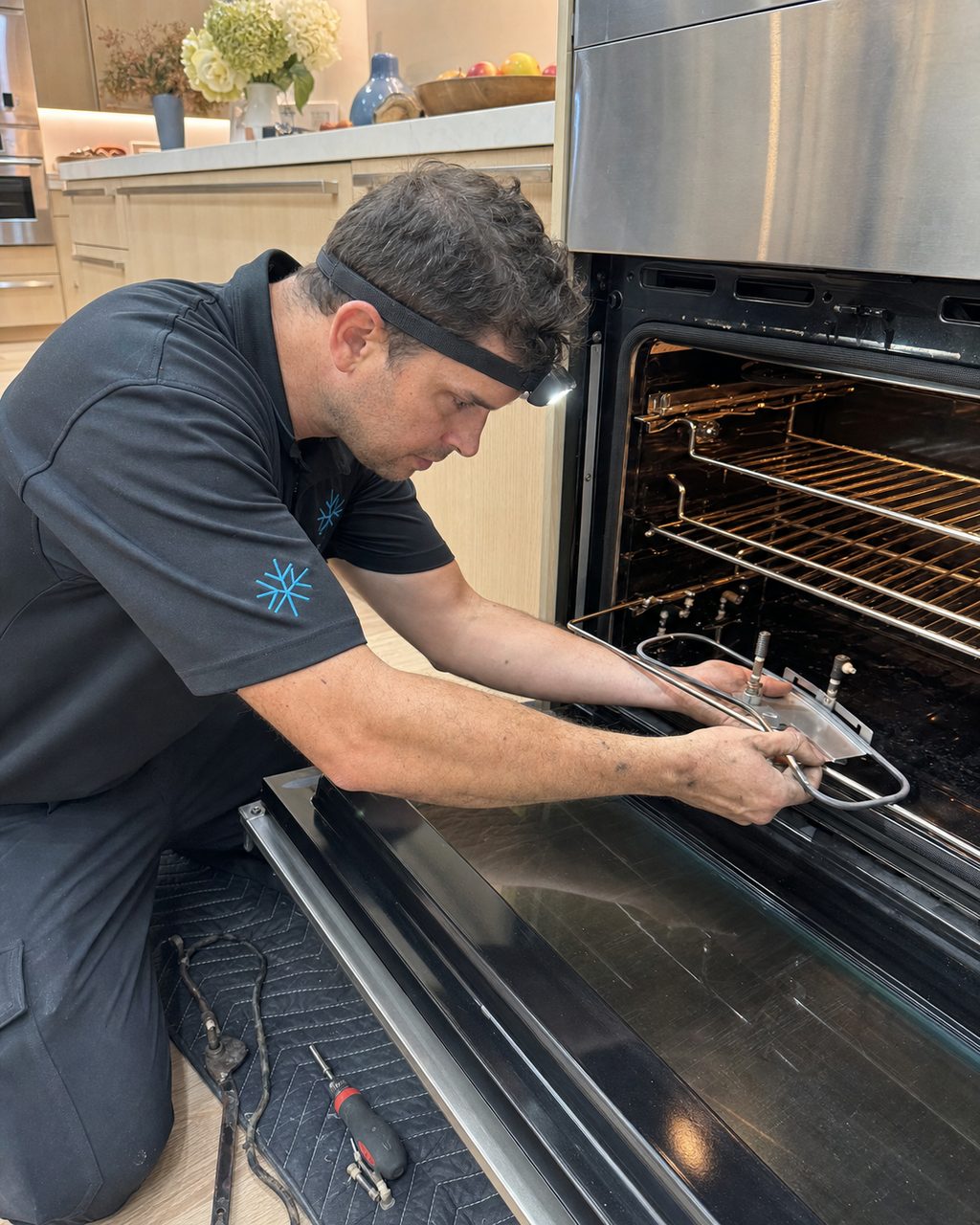 Technician replacing a Wolf oven bake element